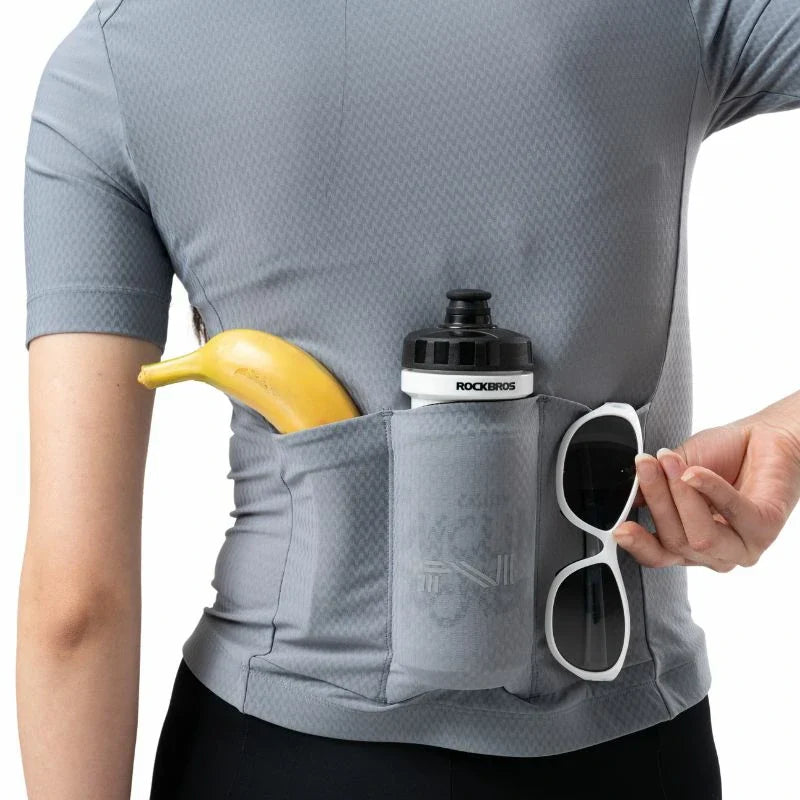 Person wearing a gray athletic outfit with a pocket holding a banana, water bottle, and sunglasses. #Color_Blue