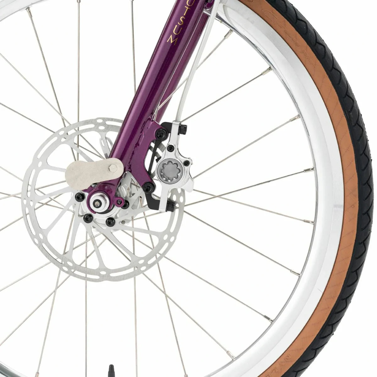 Close-up of a bicycle wheel with purple frame and brown tire on a white background #Color_Purple