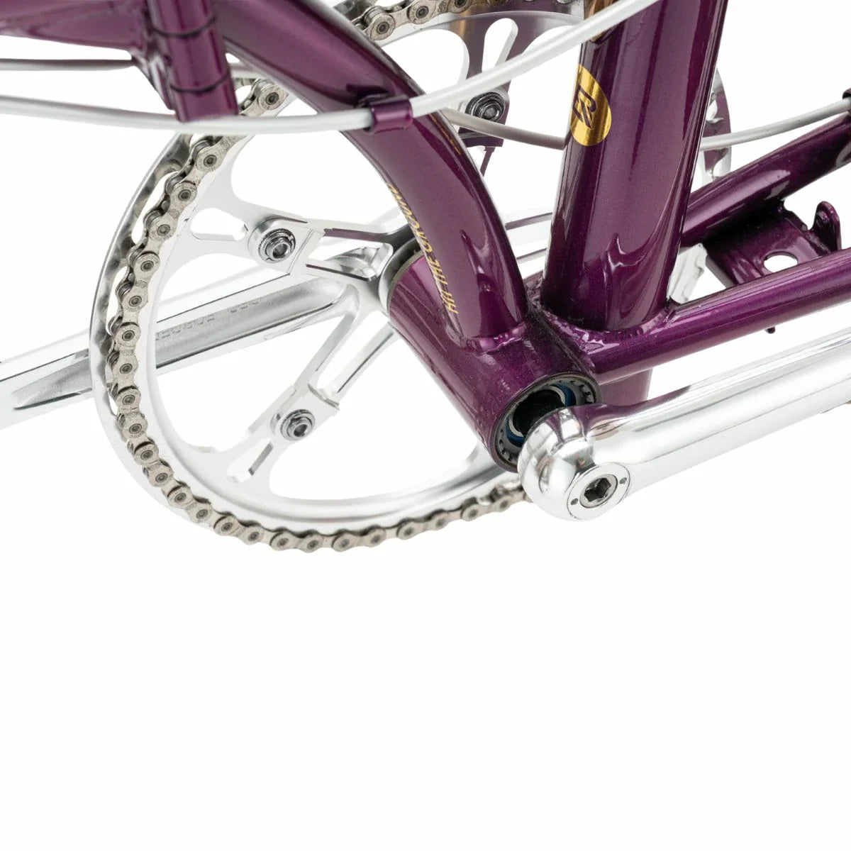 Close-up of a purple bicycle chain and gear system on a white background #Color_Purple