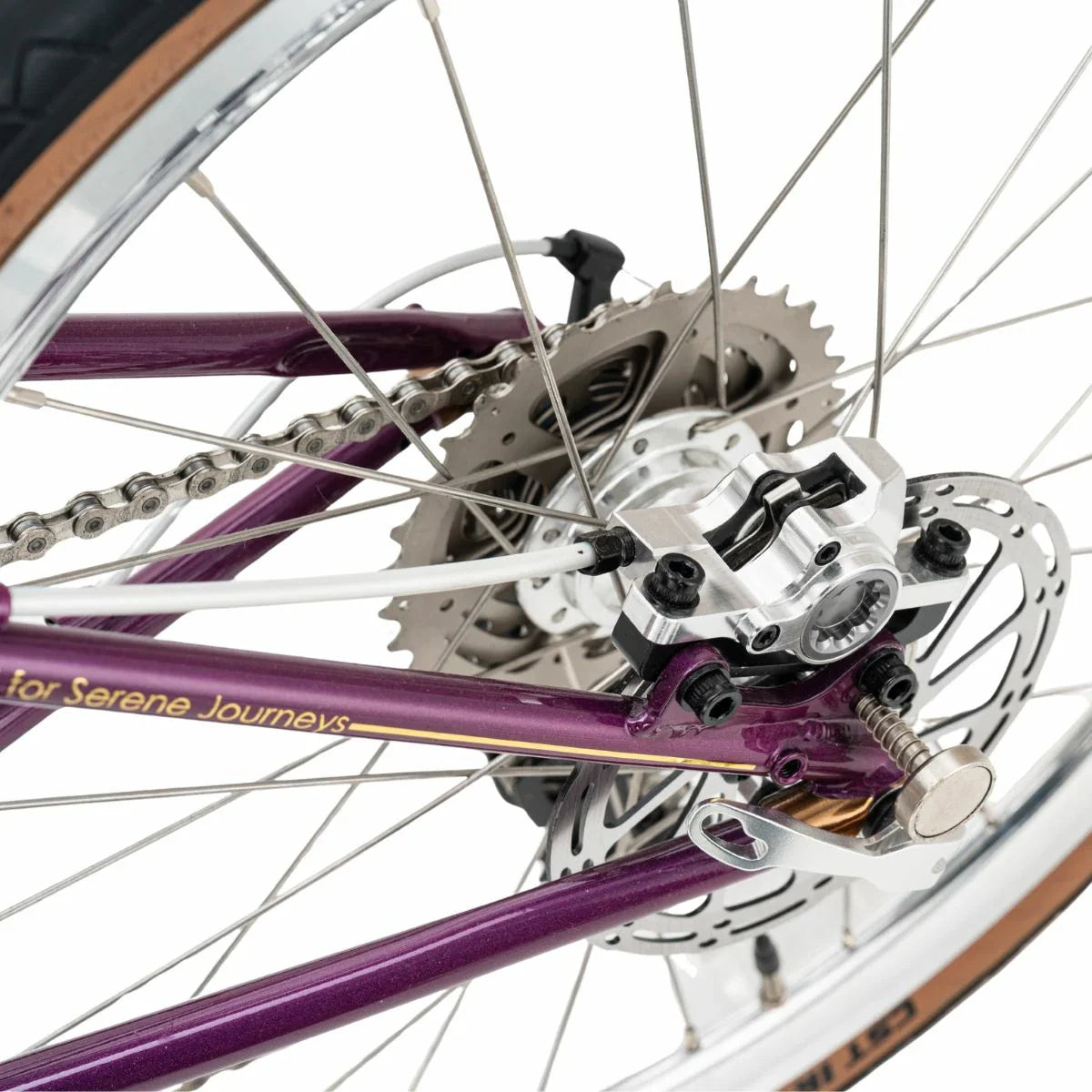 Close-up of a bicycle's gear system with a purple frame. #Color_Purple