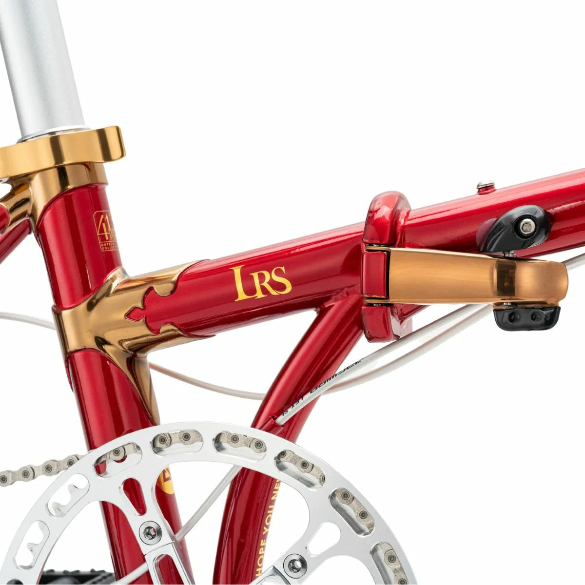 Close-up of a red bicycle frame with gold accents and 'LRS' branding. #Color_Red
