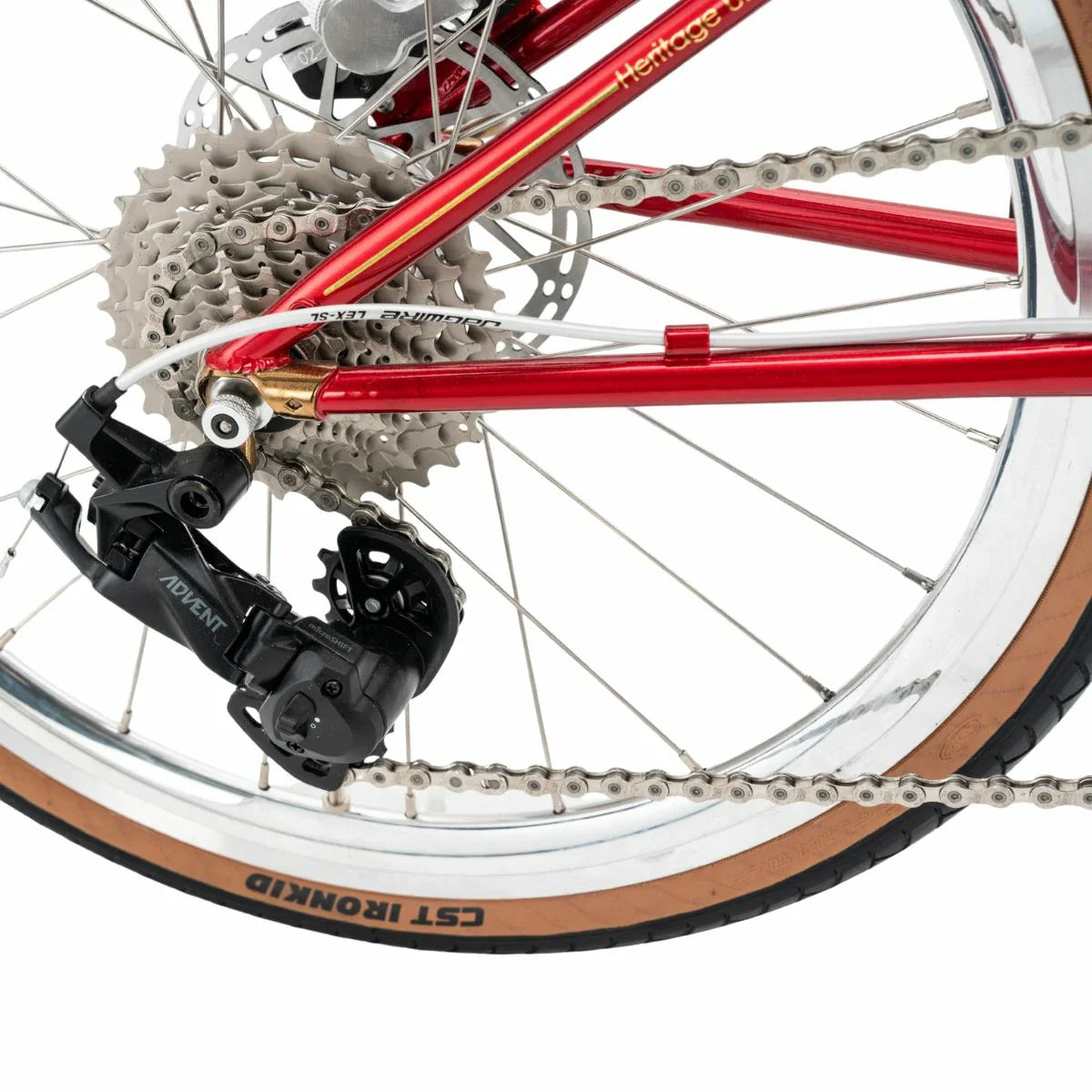 Close-up of a bicycle's gear system with red frame and black components. #Color_Red