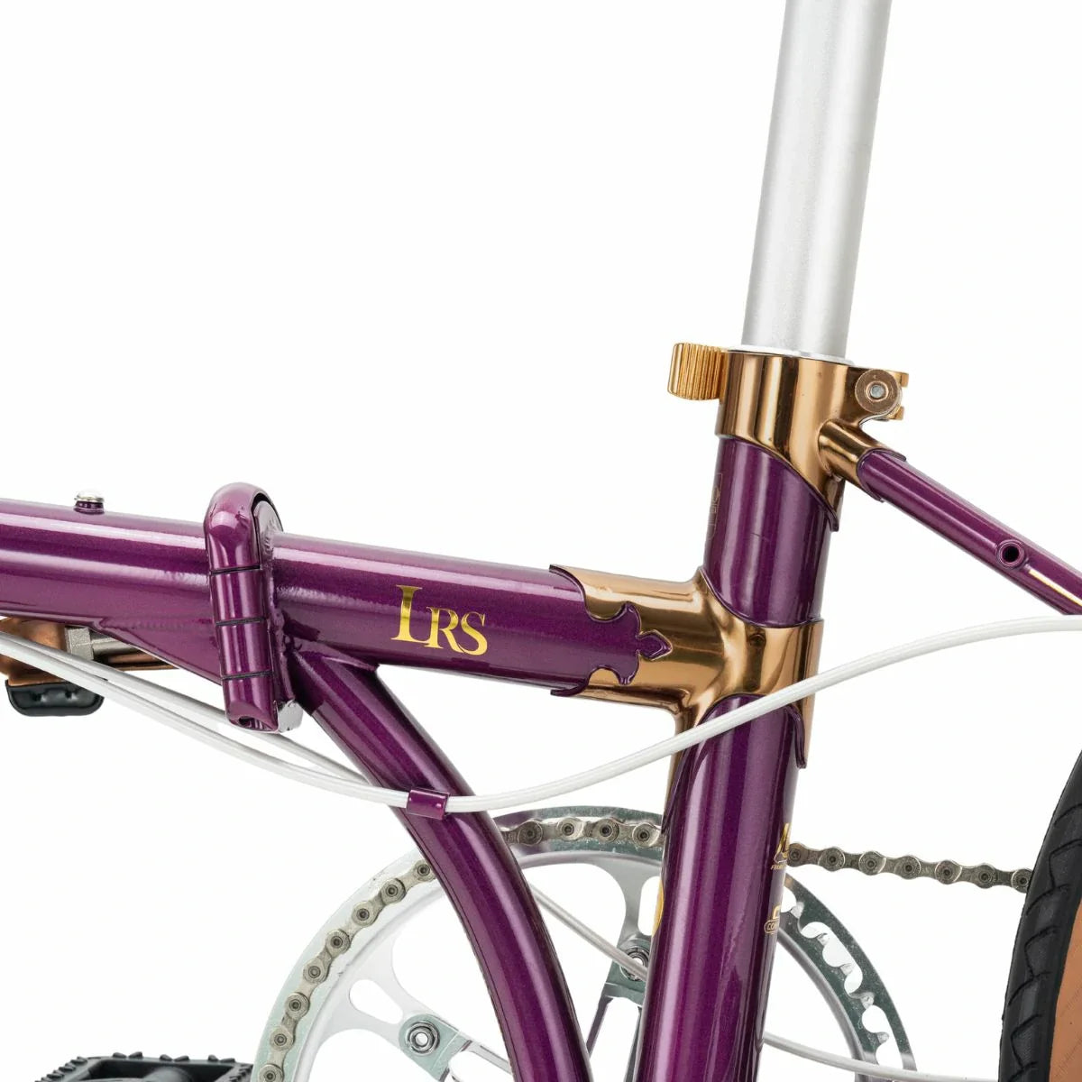 Close-up of a purple bicycle with gold accents on a white background #Color_Purple