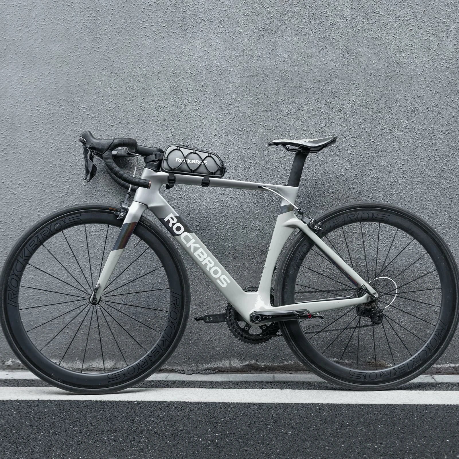 White bicycle with 'ROCKBROS' branding against a gray wall  #color_silver