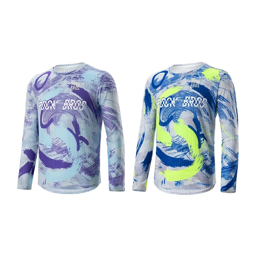 Two long-sleeve athletic shirts shown side by side on a plain white background. The left shirt has a light blue, purple, and white abstract brushstroke pattern with 'ROCKBROS' printed across the chest. #Color_Blue+Purple 
