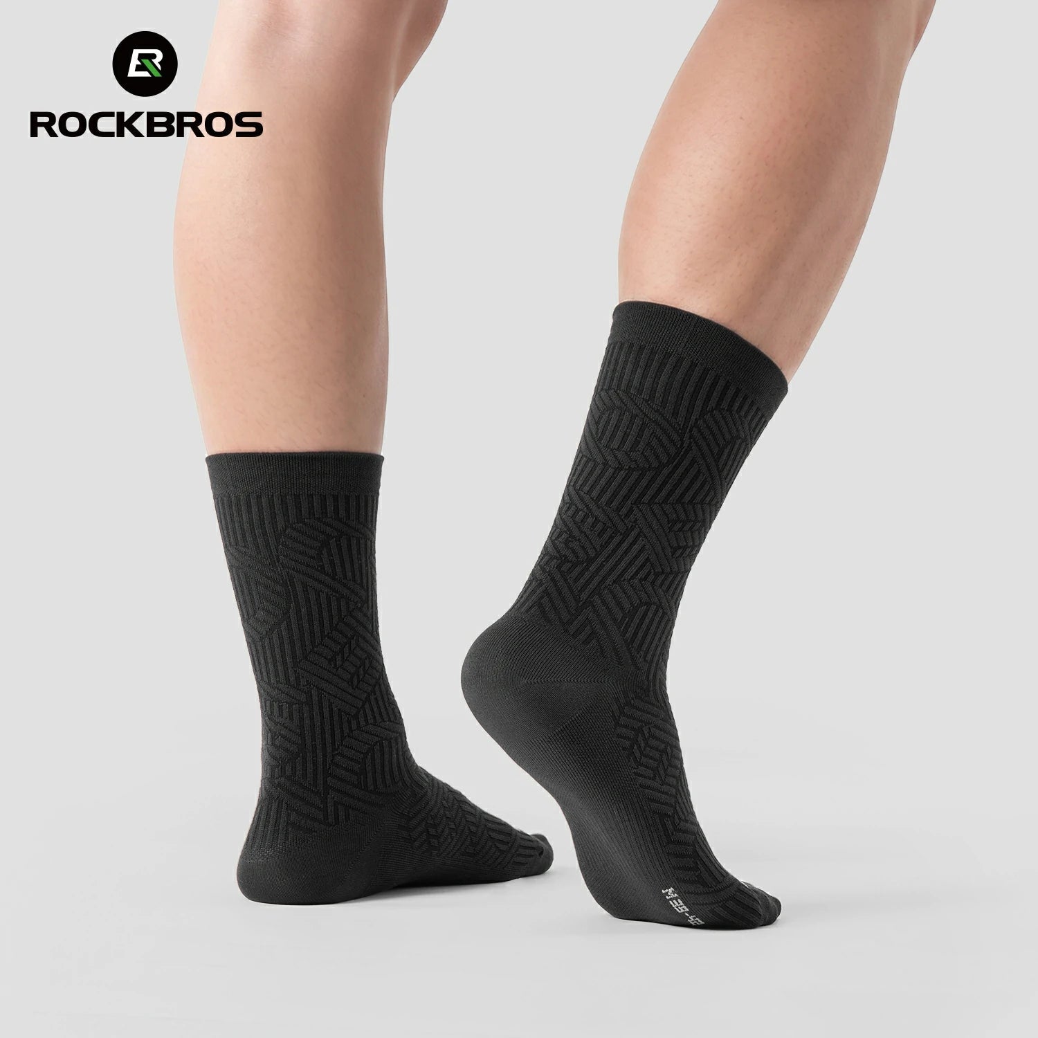 Black socks with geometric pattern worn by a person on a light gray background, featuring the RockBros brand.