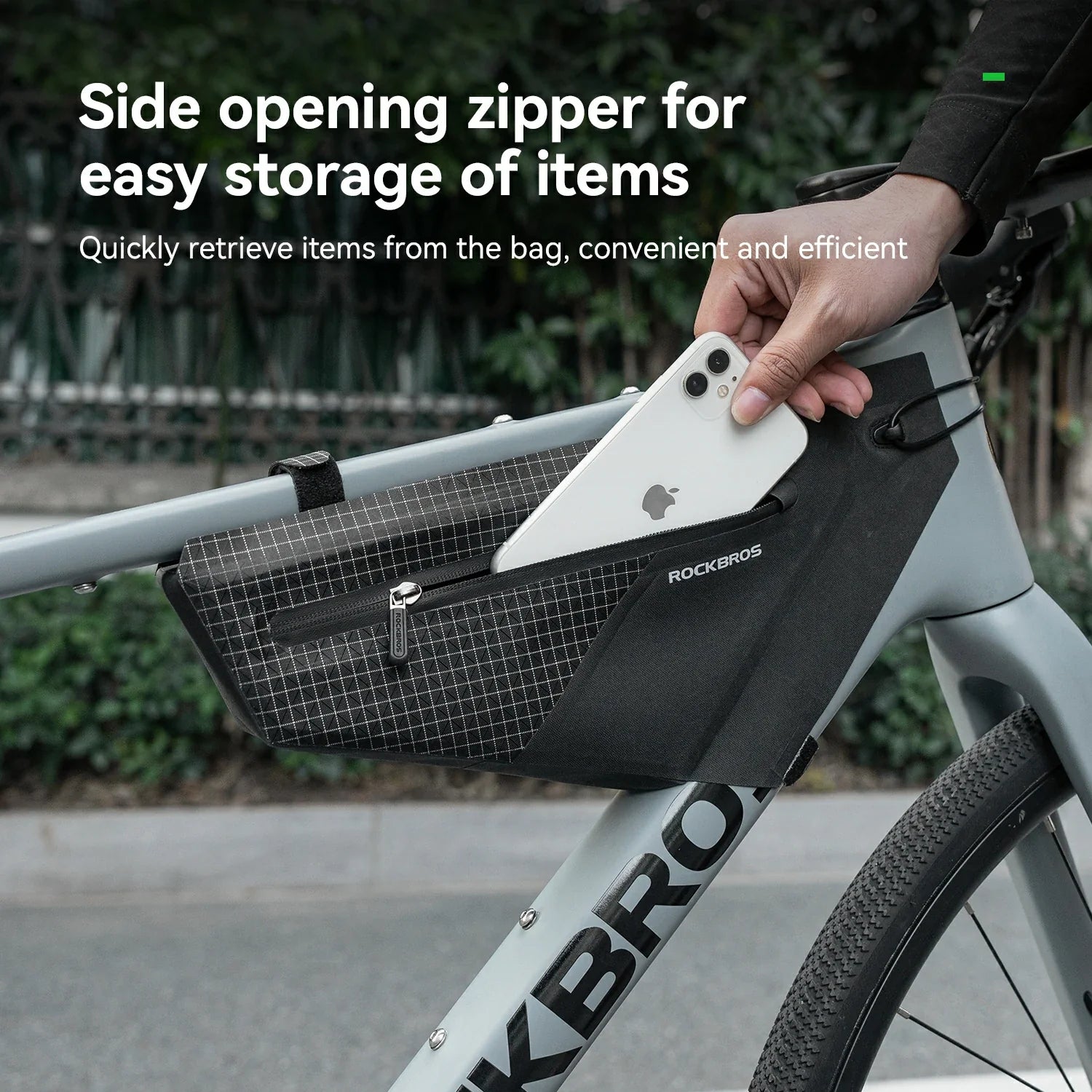 Bicycle frame bag with side opening zipper, showing a hand retrieving an item.