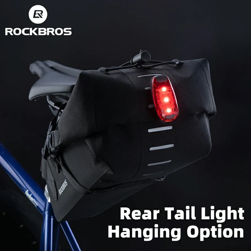 Black bicycle tail light bag with red light on a dark background, featuring RockBros branding.