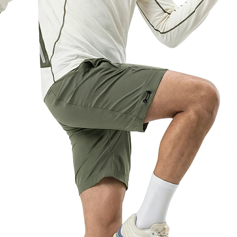 Person wearing green shorts and white socks on a white background