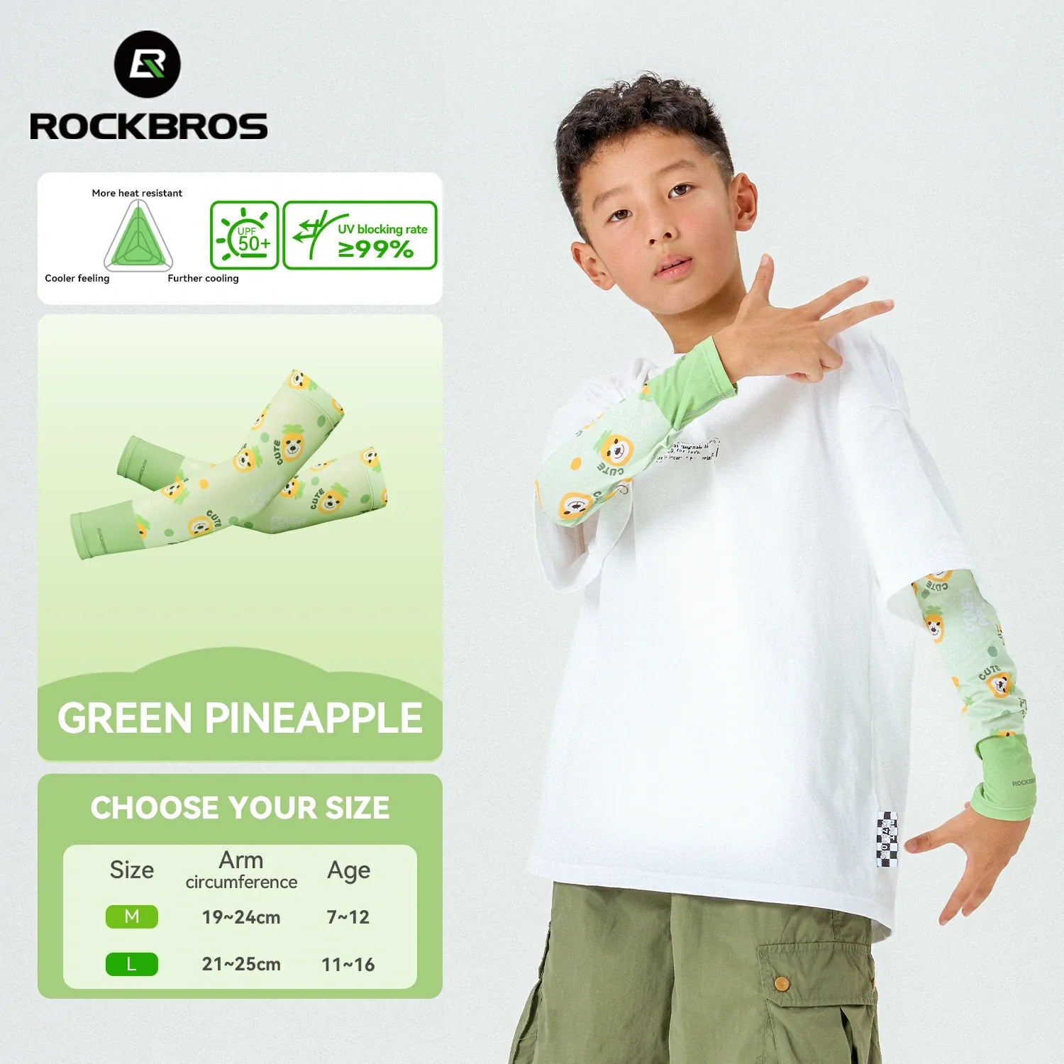 Child wearing a white shirt with green pineapple designs on sleeves, standing next to product packaging. #Color_Green