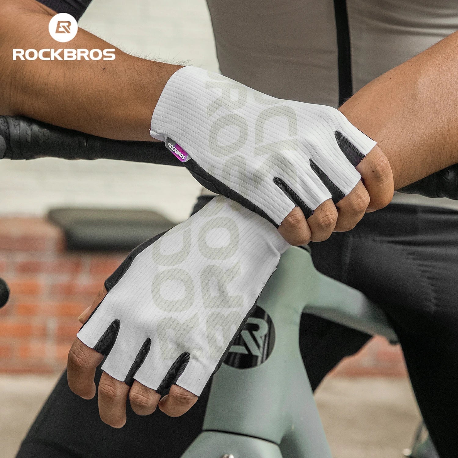 Person wearing white cycling gloves with black accents on a bicycle, featuring the RockBros brand.#color_White
