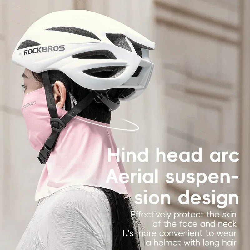 Person wearing a white helmet with 'RockBros' branding, suitable for those with long hair.