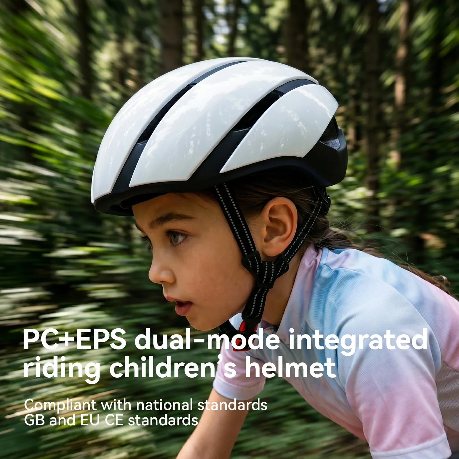 A child wearing a white and black integrated helmet with a pink and blue tie-dye shirt, riding outdoors on a blurred forest path. Text overlay reads 'PC+EPS dual-mode integrated riding children's helmet' and 'Compliant with national standards GB and EU CE standards.