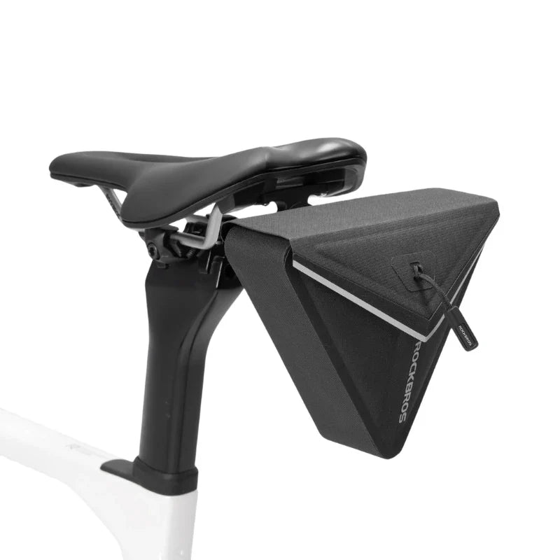 Bicycle seat with a black triangular bag attached on a white background 