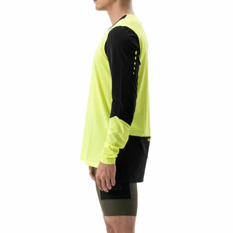 Person wearing a bright yellow and black long-sleeve athletic shirt on a white background