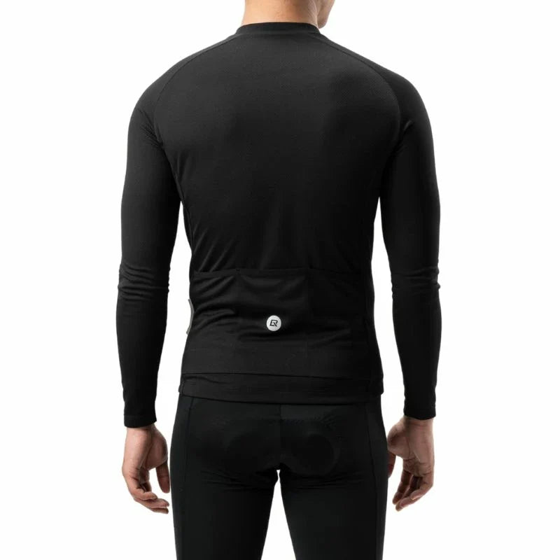 Rear view of a person wearing a black long-sleeve cycling base layer with a built-in rear pocket and a small circular logo, paired with black cycling shorts against a white  background. #Color_Black