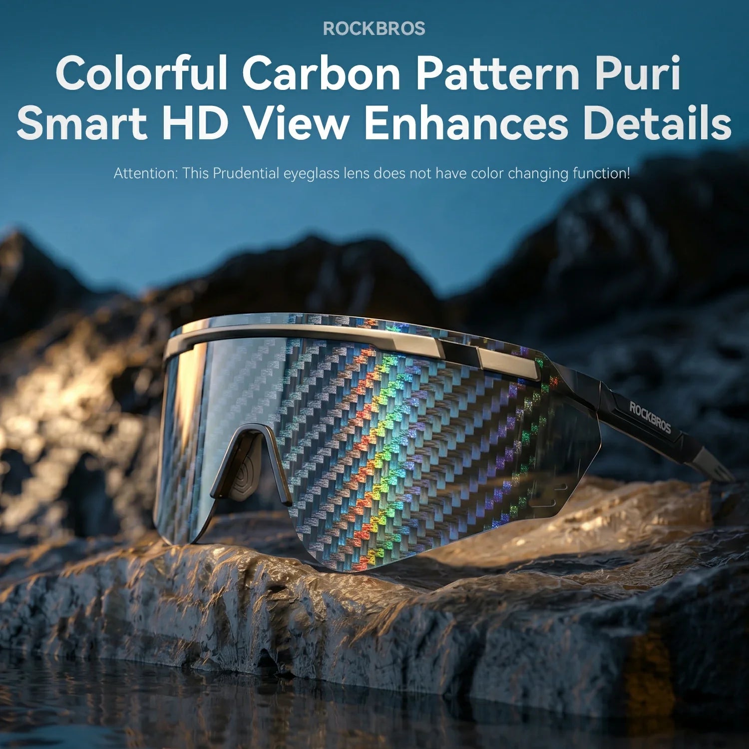 Rockbros eyeglasses with a colorful carbon pattern lens, resting on a rocky cliffside with a mountainous background under a blue sky.