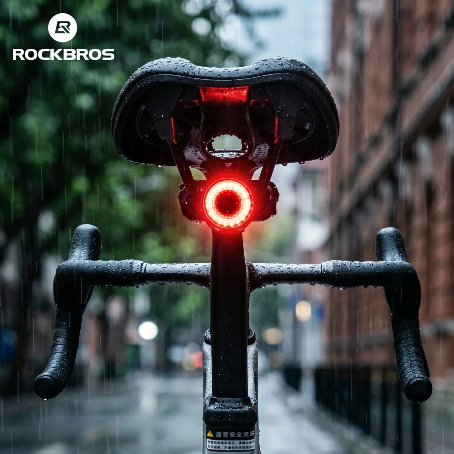 Bicycle with a red light on a rainy street, featuring the Rockbros brand.