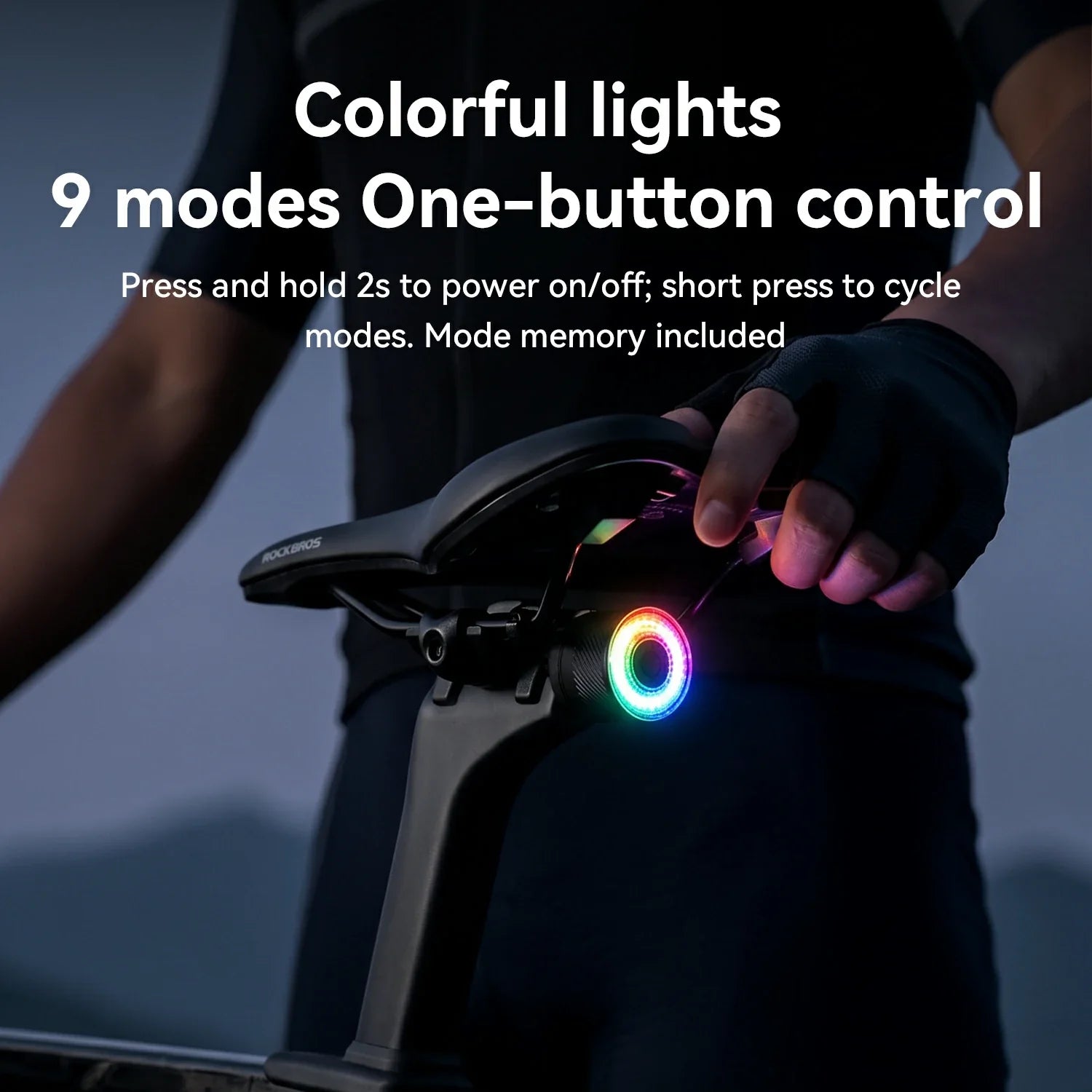 Person holding a bicycle with colorful lights and one-button control system.