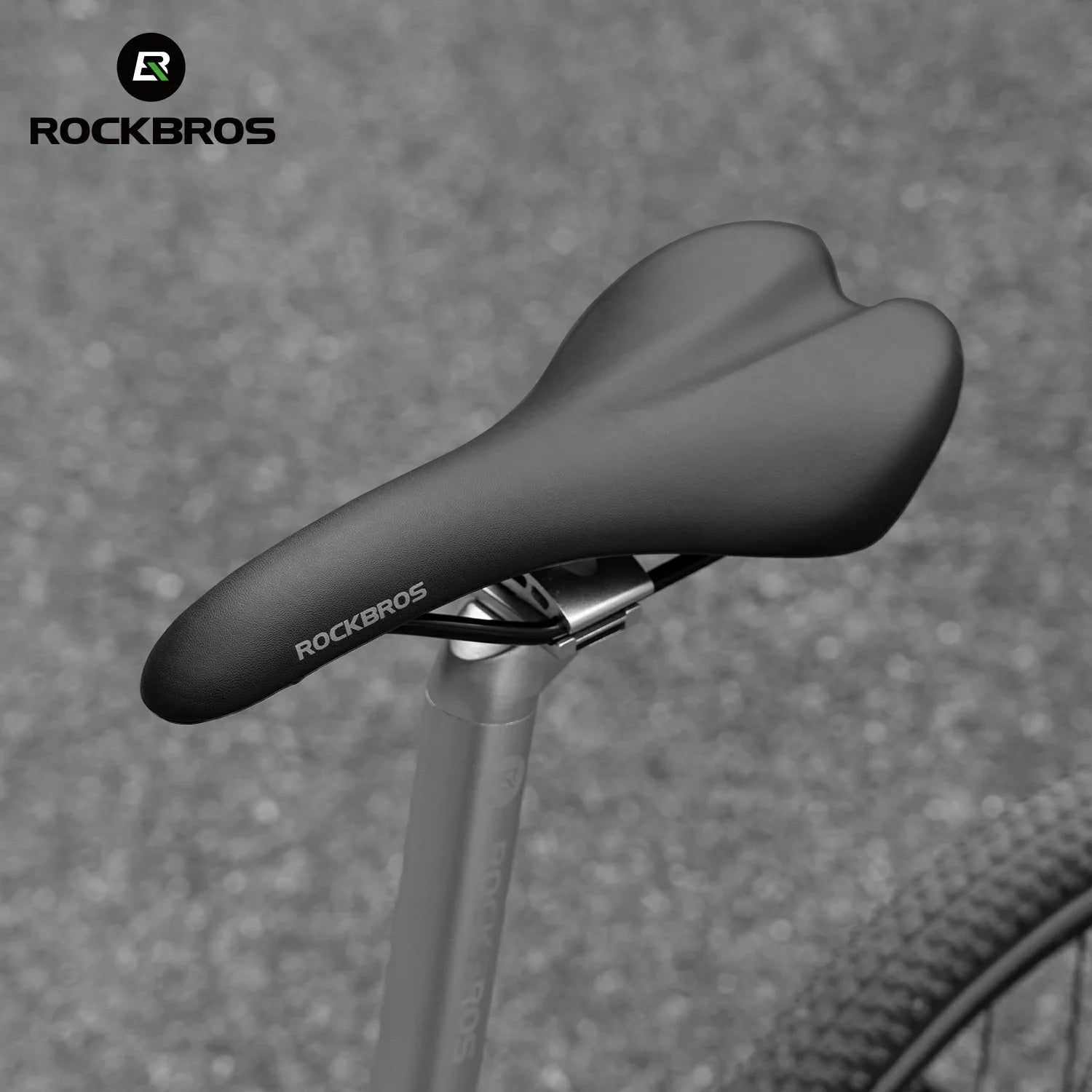 Bicycle saddle with RockBros branding on a textured gray background