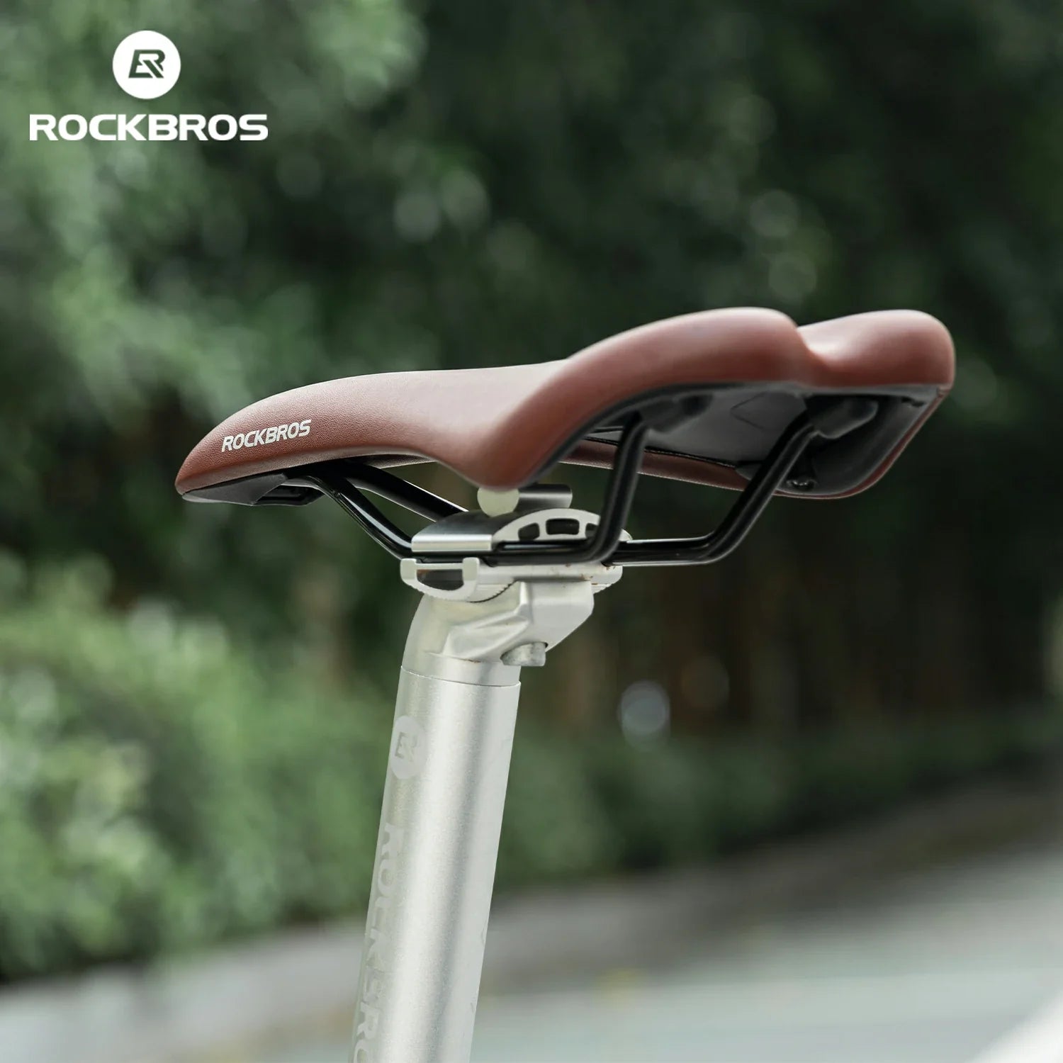 Bicycle seat with Rockbros branding on a blurred green background