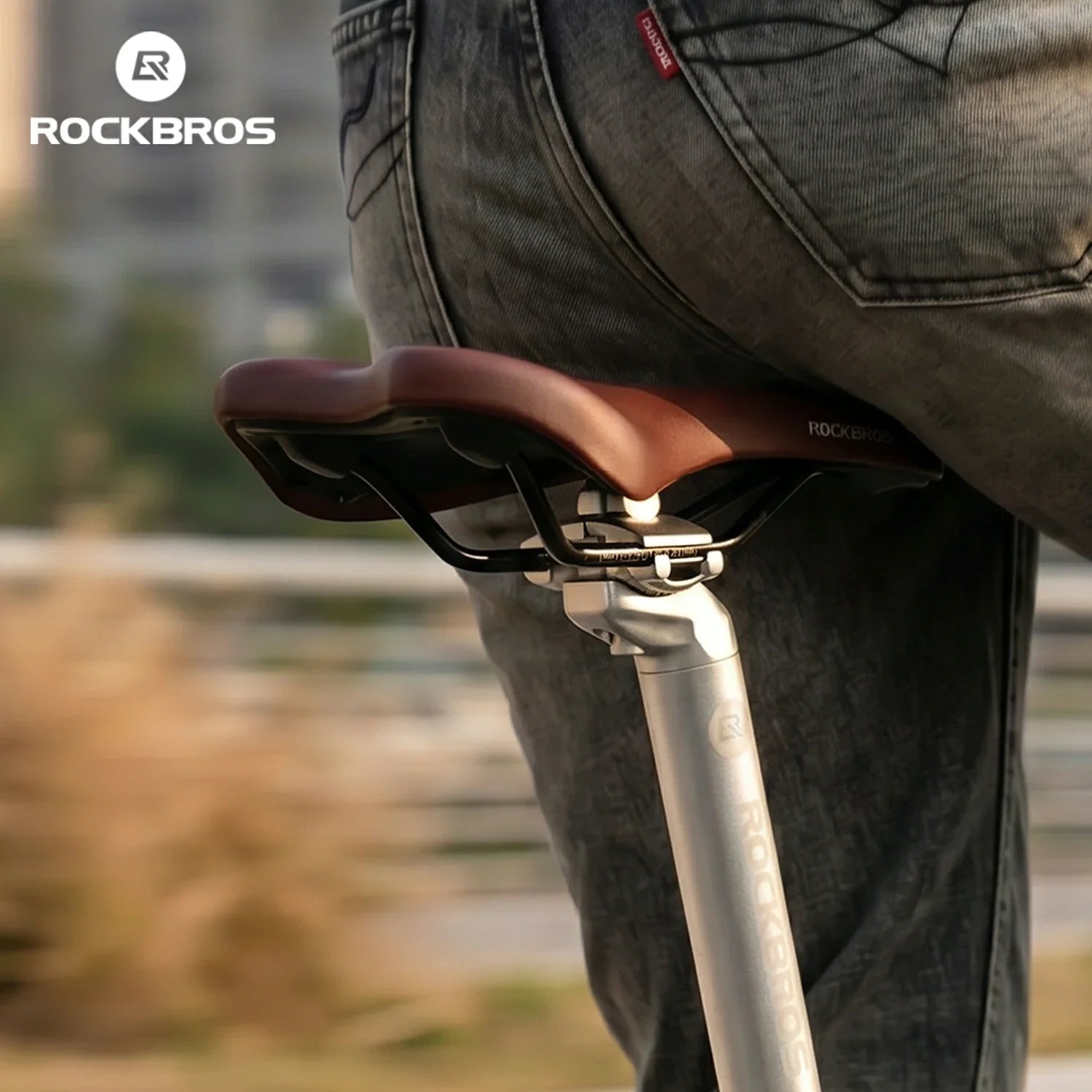 Close-up of a bicycle seat with 'RockBros' branding, blurred background
