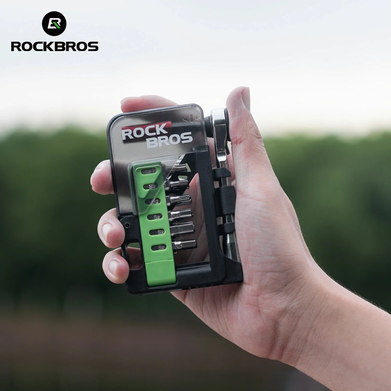 Hand holding a compact tool set with 'RockBros' branding 