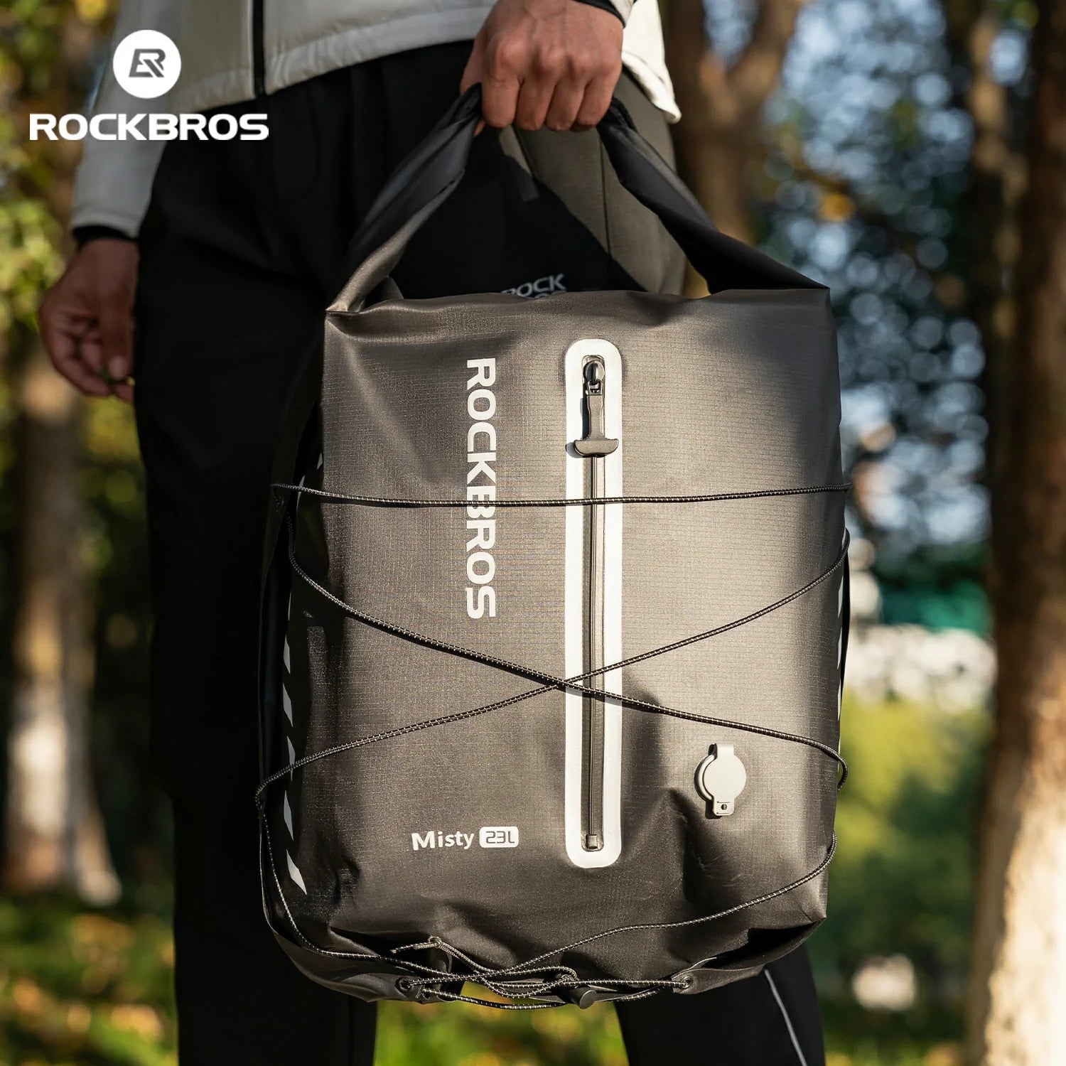Person holding a black bag with 'ROCKBROS' branding outdoors #color_black