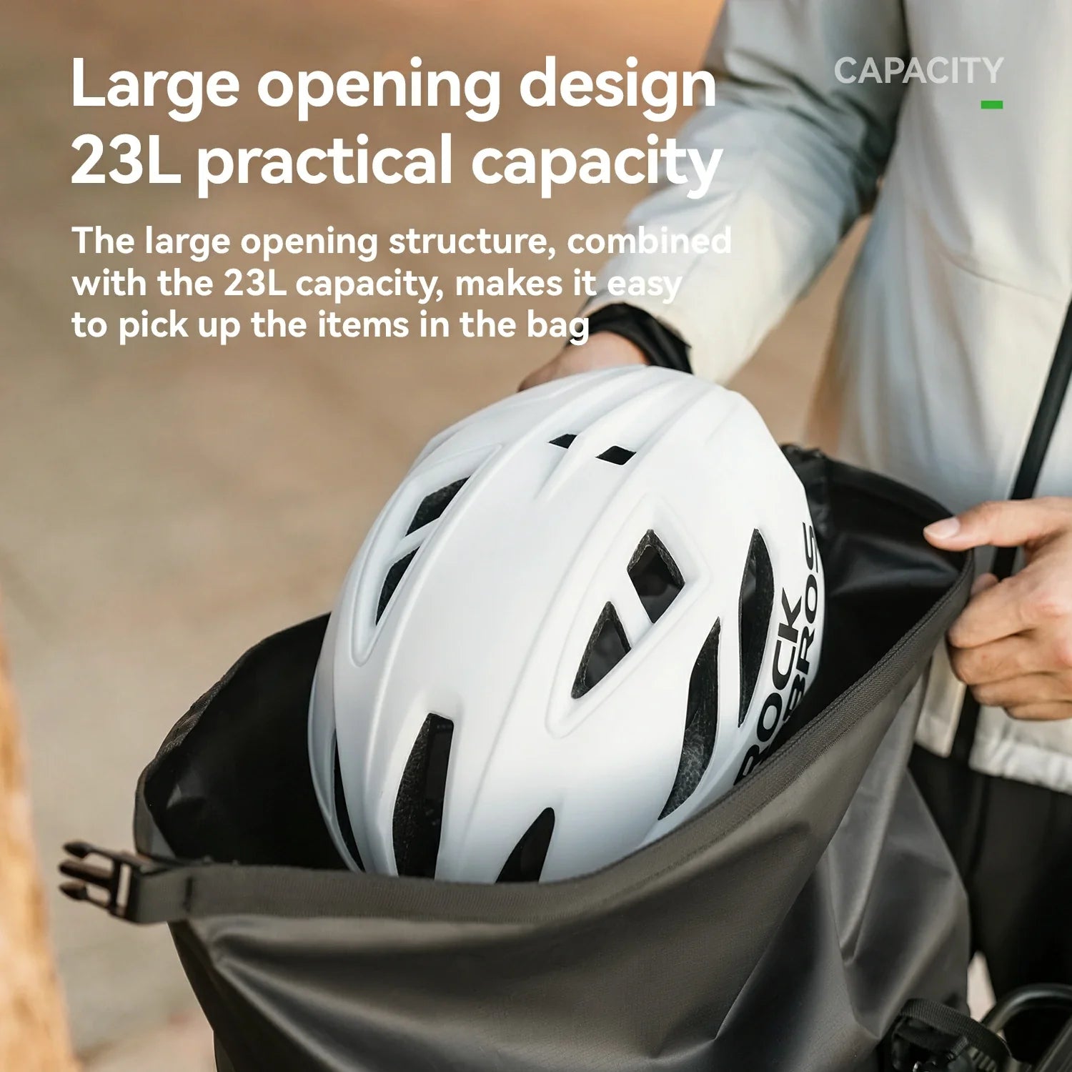 Person holding a bag with a helmet inside, text about large opening design and 23L capacity.