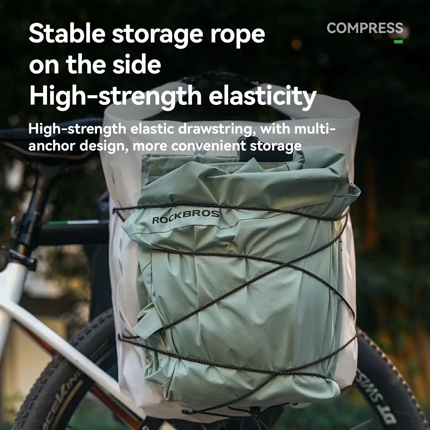 Bicycle with a green storage bag and compression rope, featuring text about stable storage and high-strength elasticity.