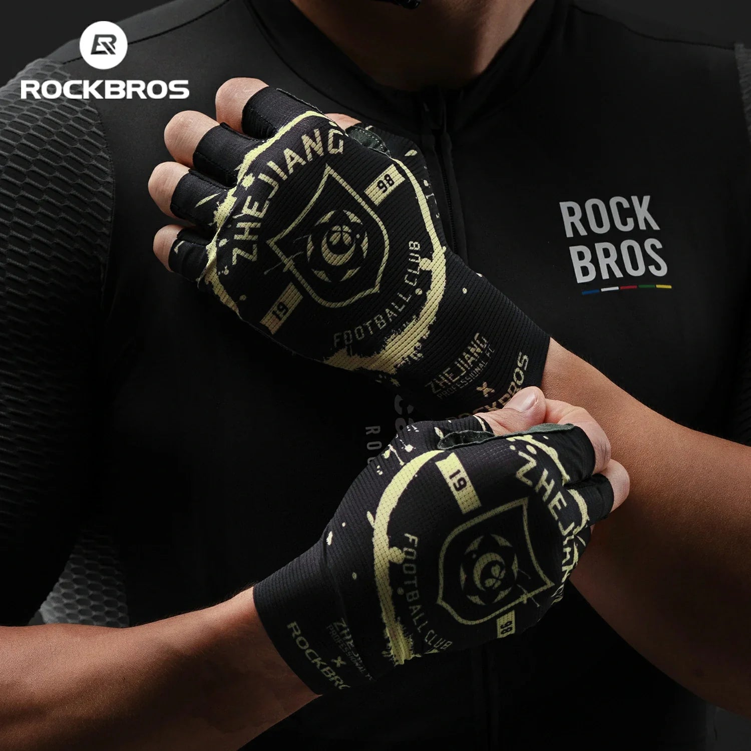 Person wearing black and yellow gloves with 'RockBros' branding, against a dark background.
