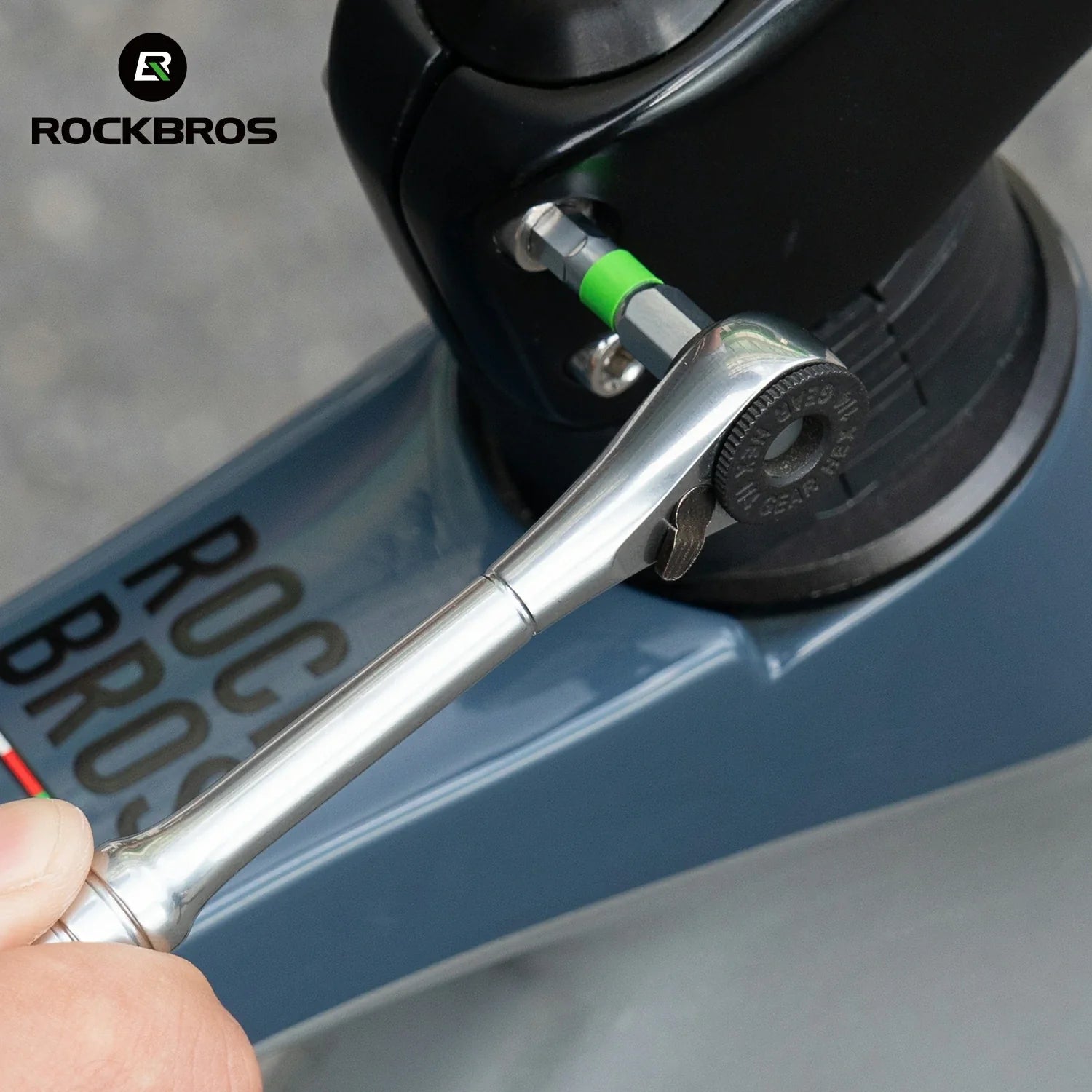 Person using a wrench on a scooter with 'RockBros' branding.