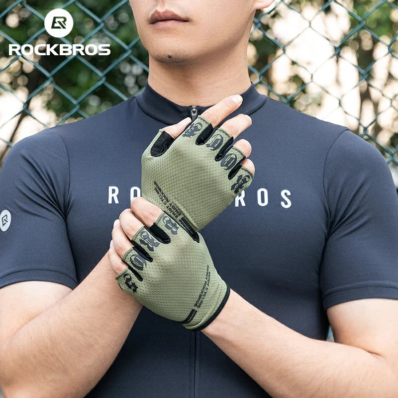 Person wearing a navy blue cycling jersey and green cycling gloves with 'RockBros' branding. #color_green