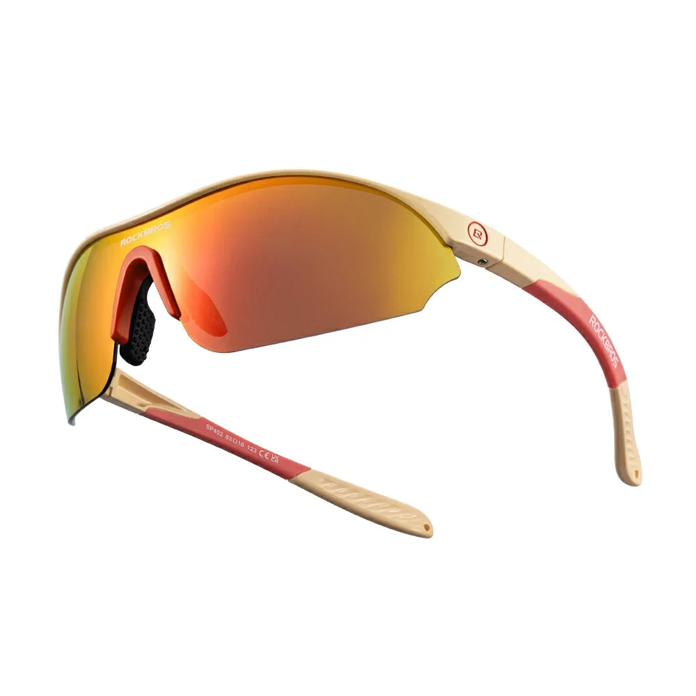 Sunglasses with red-tinted lenses and gold frame on a white background #Color_Brown