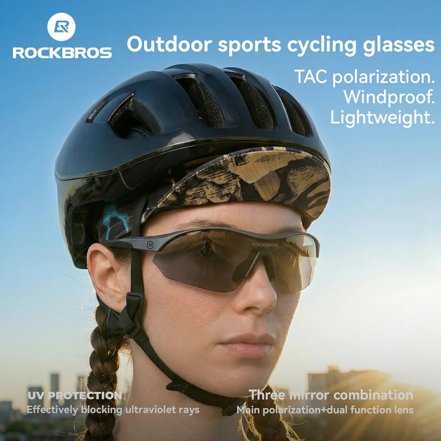 Person wearing a black helmet and sunglasses with a clear blue sky background, promoting ROCKBROS outdoor sports cycling glasses.