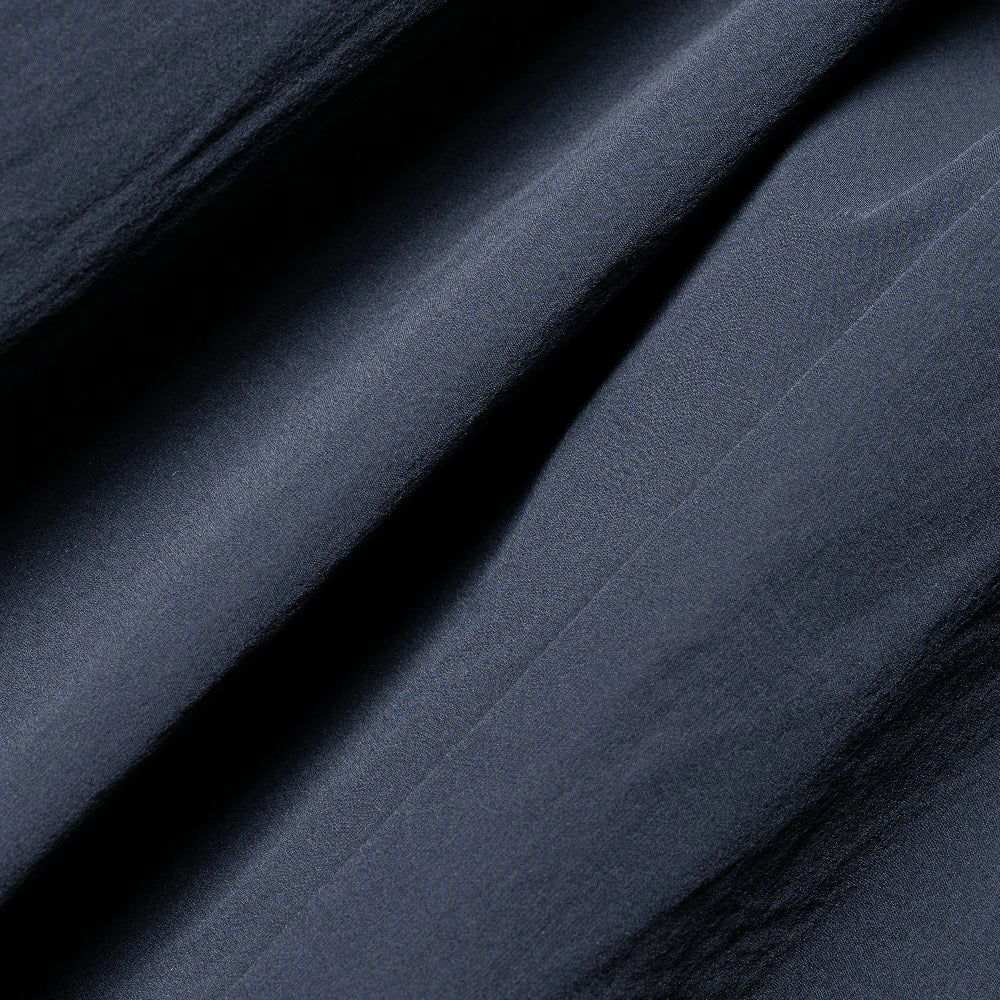 Close-up of dark blue fabric with folds