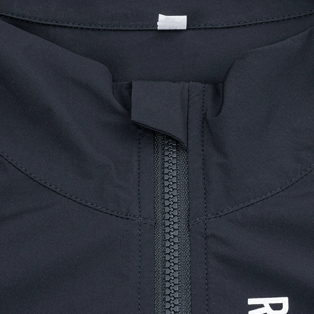 Close-up of a dark blue jacket with a zipper and brand logo.