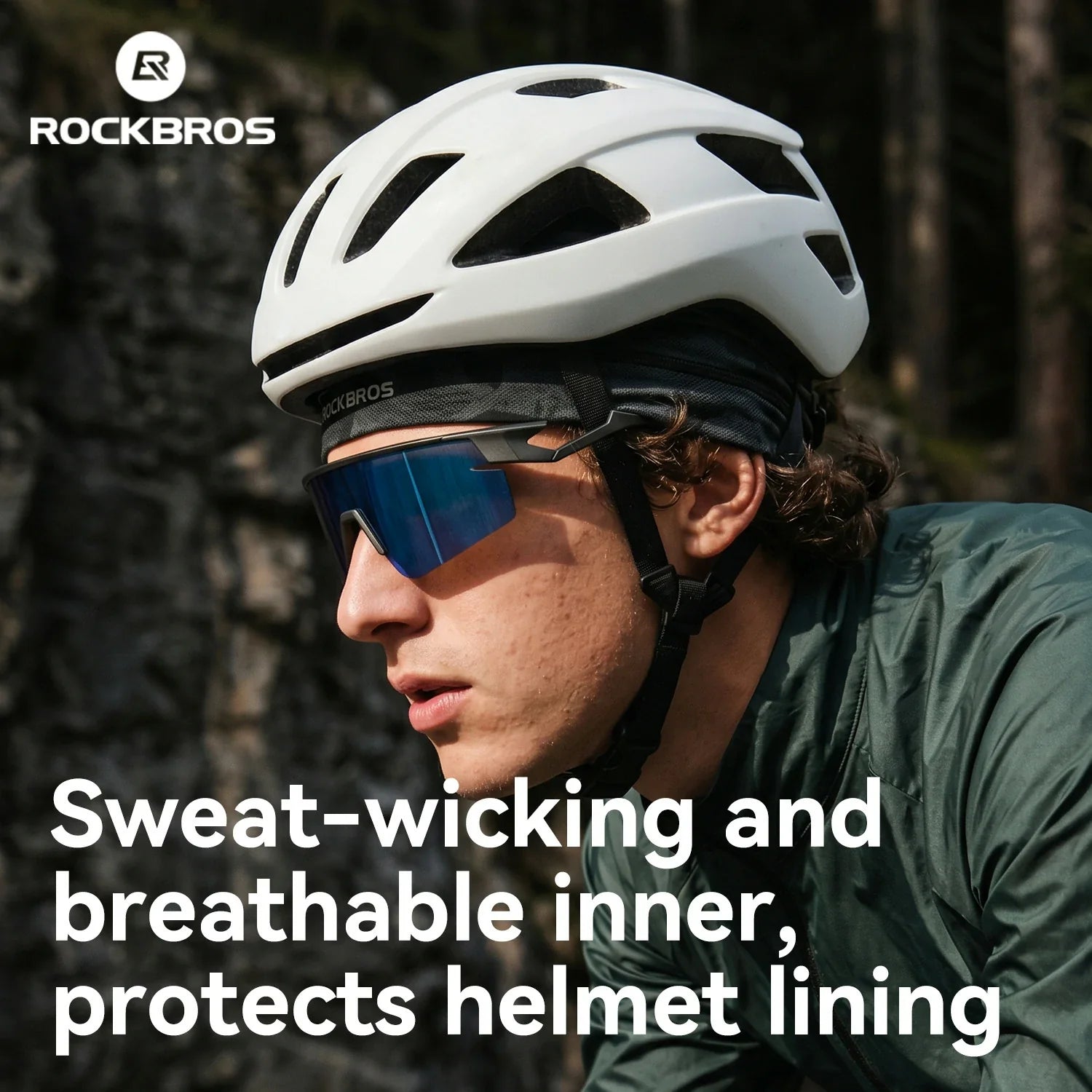 Person wearing a white helmet and sunglasses with a forest background, featuring RockBros branding.