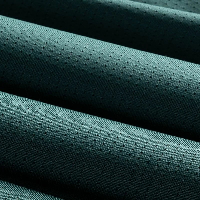 Teal fabric with a textured pattern on a black background #Color_Green