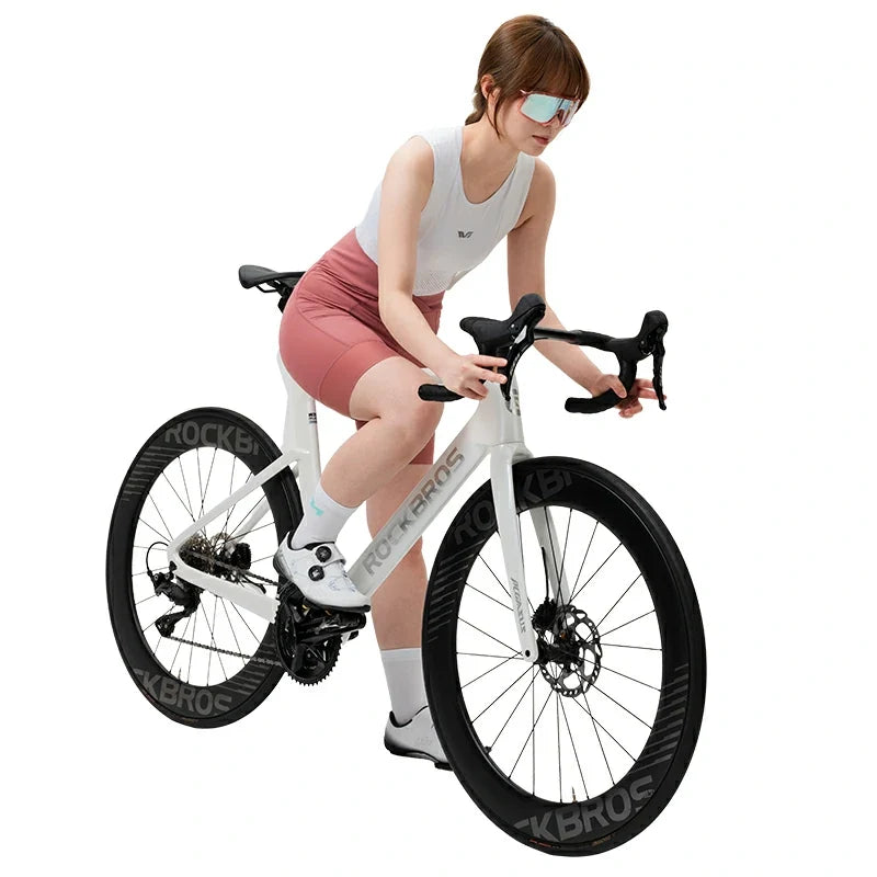 Woman sitting on a white bicycle with black tires on a white background #color_Pink