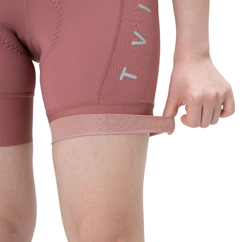 Close-up of pink athletic shorts with a brand logo on a white background