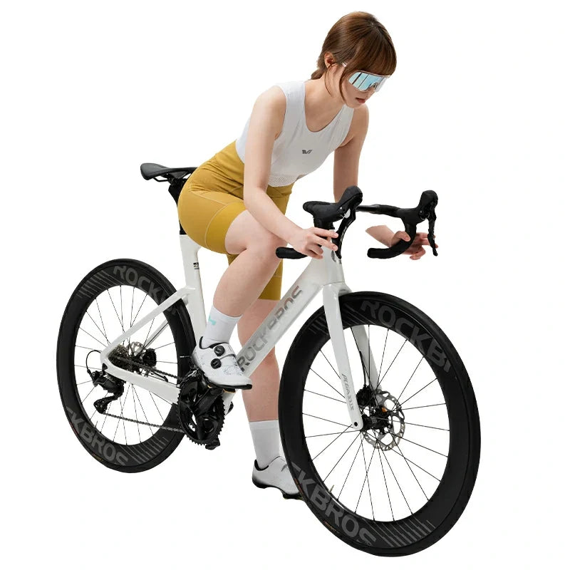 Woman sitting on a white bicycle with black tires on a white background  #color_Yellow
