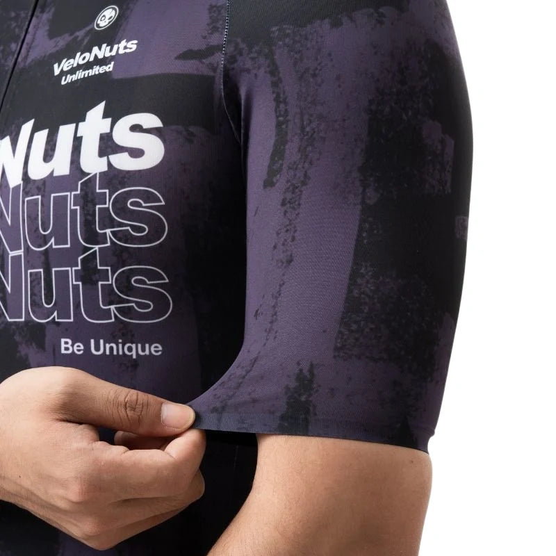 Close-up of a purple cycling jersey with 'VeloNuts Unlimited' branding and text.