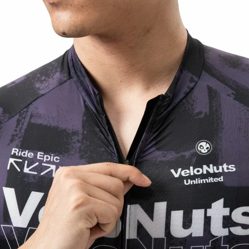 Person wearing a purple cycling jersey with visible branding on a white background