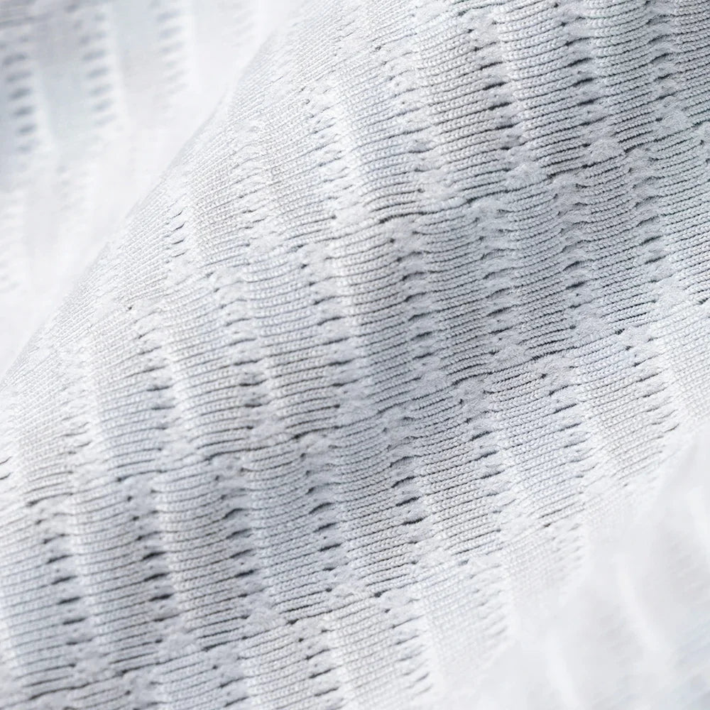 Close-up of textured white fabric with a subtle pattern